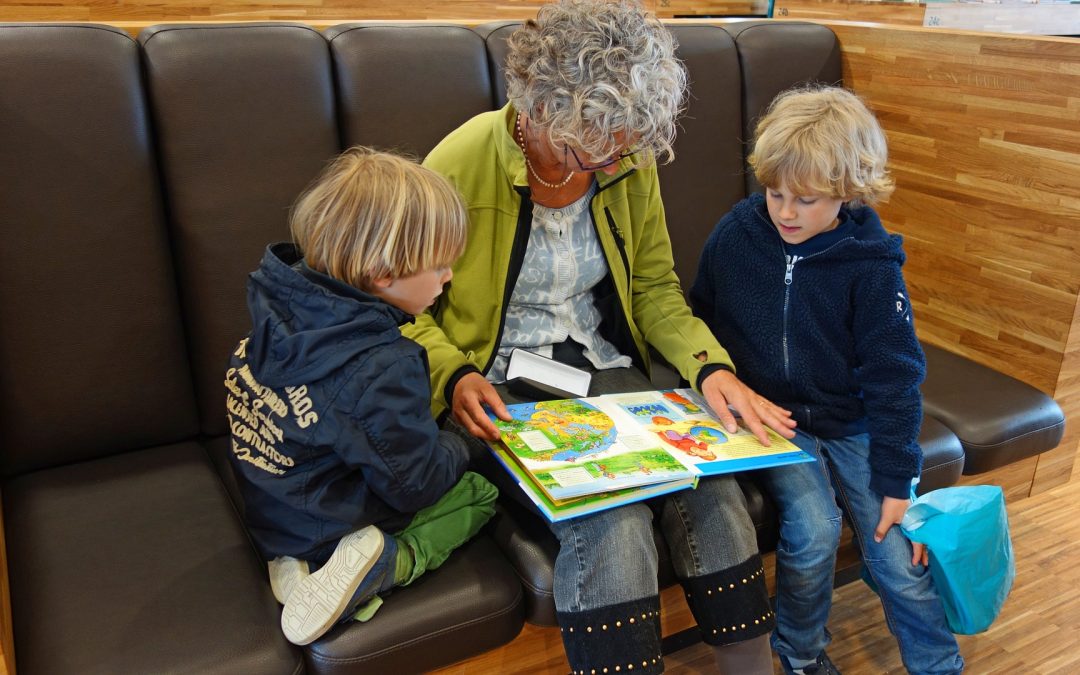 children reading with older woman
