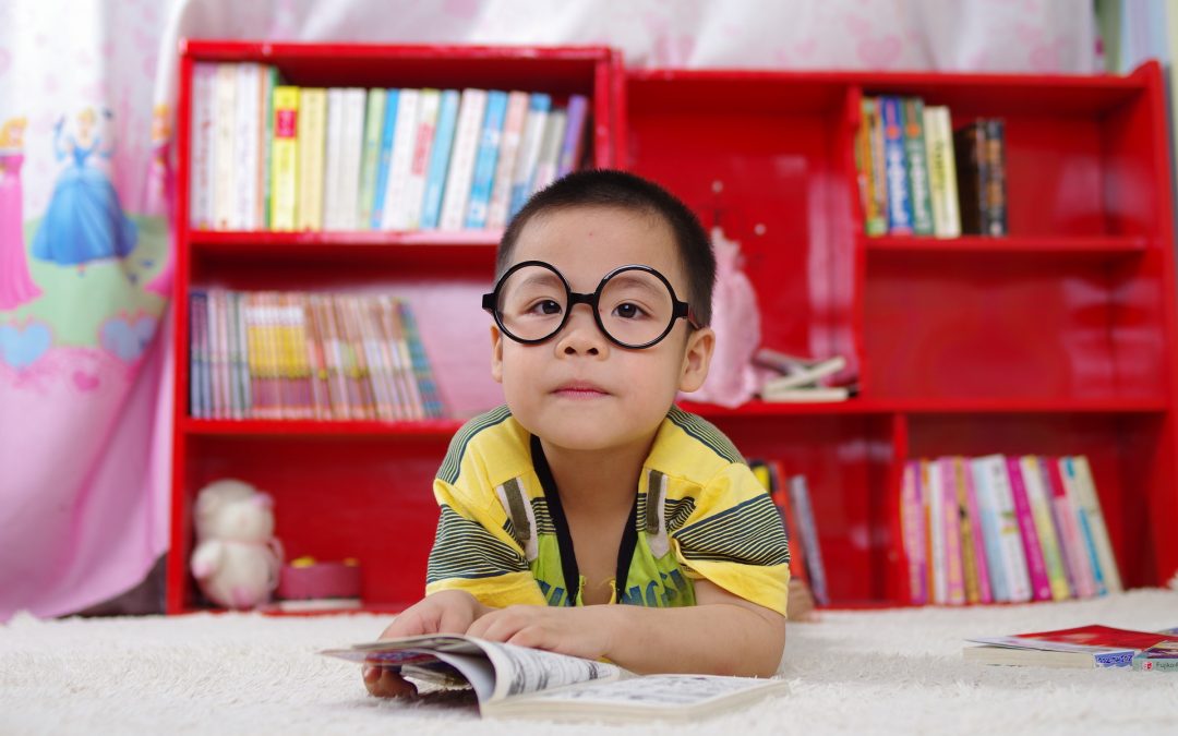 boy with glasses reading book